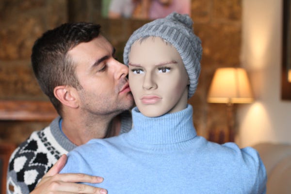 Man snuggling and kissing a mannequin