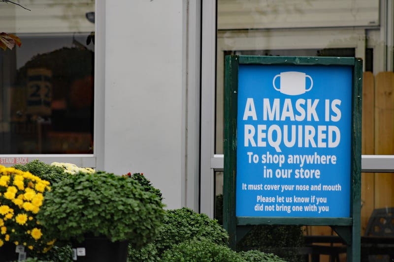A store mandates that people wear face coverings.
