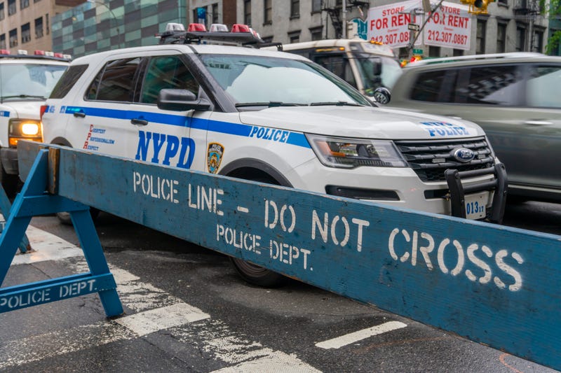 Police are searching for a mna who crashed into two pedestrians on a Queens street early Sunday morning while fleeing a traffic stop.