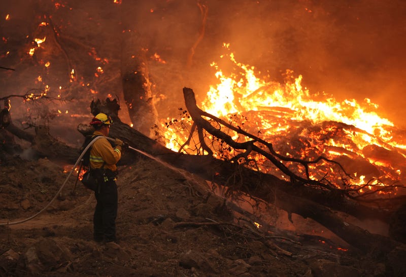A firefighter sprays water on hot spots while battling the Glass Fire on October 01, 2020 in Calistoga, California.