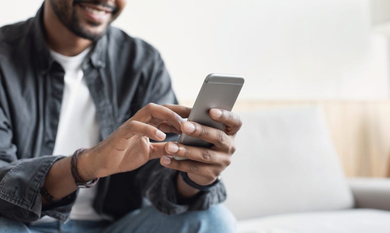 A man dialing on a phone.