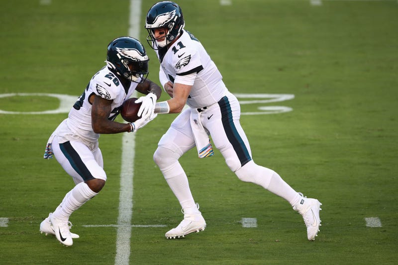 Carson Wentz #11 hands the ball of to Miles Sanders #26 of the Philadelphia Eagles