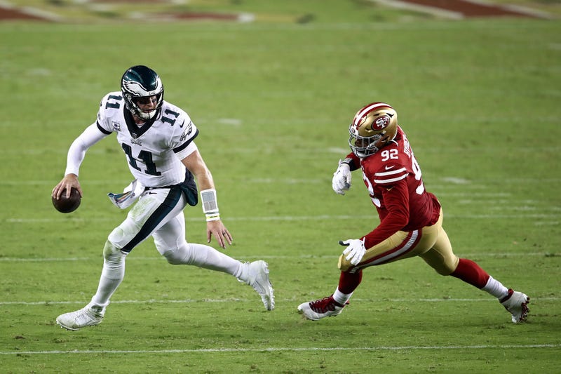 Eagles quarterback Carson Wentz tries to elude the 49ers' pass rush
