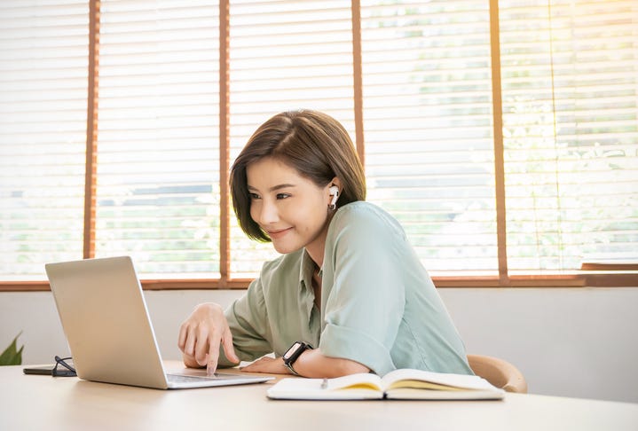college student with airpods and laptop