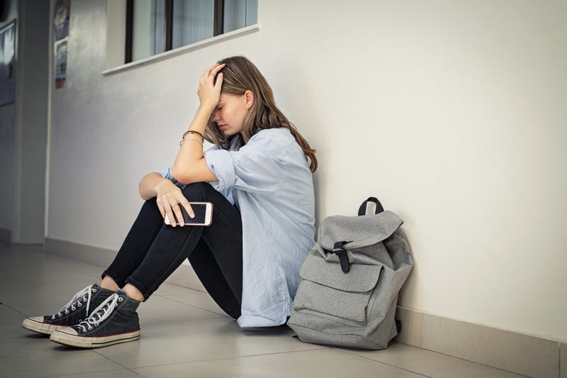 Teen holding head 