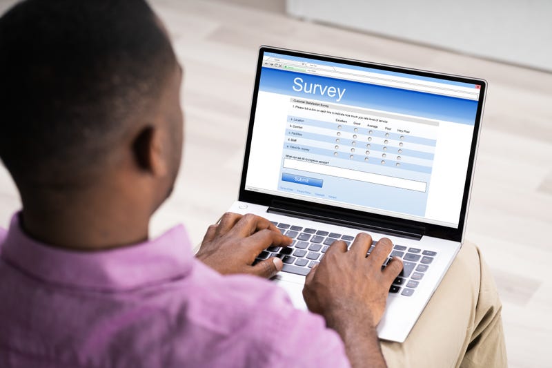 man taking survey on laptop