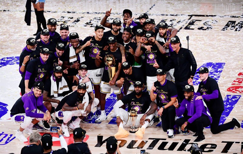 The Los Angeles Lakers pose for a team photo with the trophy after winning the 2020 NBA Championship over the Miami Heat in Game Six of the 2020 NBA Finals at AdventHealth Arena at the ESPN Wide World Of Sports Complex on October 11, 2020 in Lake Buena Vista, Florida.