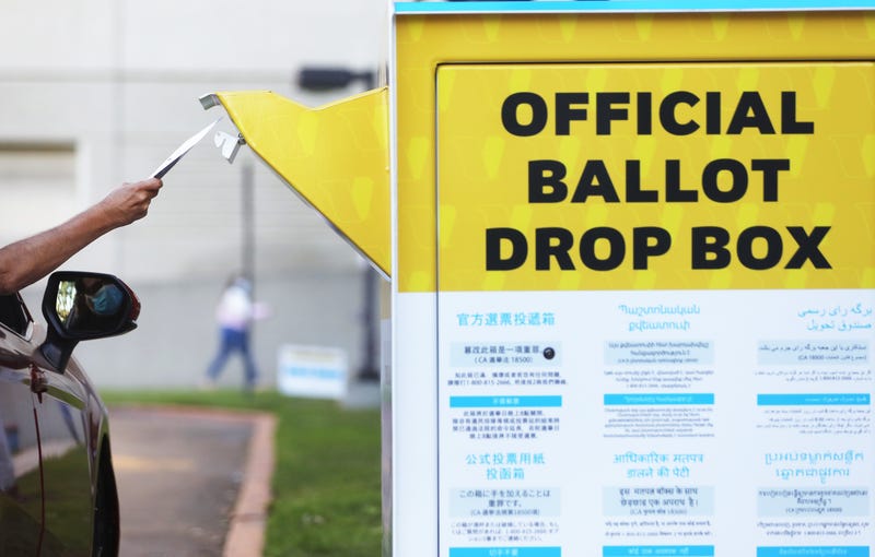 A car passenger places a ballot in an official mail-in ballot drop box outside of the L.A. County Registrar’s office ahead of Election Day on October 14, 2020 in Norwalk, California.