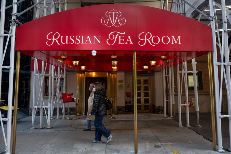 People wearing masks walk past the recently reopened Russian Tea Room on October 17, 2020 in New York City.
