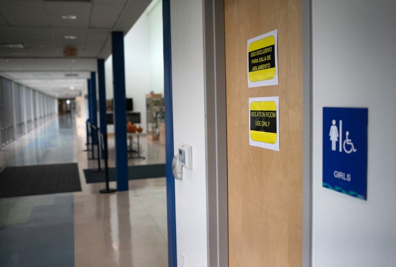 STAMFORD, CONNECTICUT - OCTOBER 21: Signs mark a bathroom next to an "isolation room" set up for students or faculty with potential COVID-19 symptoms at Rogers International School on October 21, 2020 in Stamford, Connecticut. Stamford Public Schools is continuing the fall semester with a hybrid model of in-class and distance learning, occasionally quarantining individual classes when a student or faculty member tests positive for COVID-19.