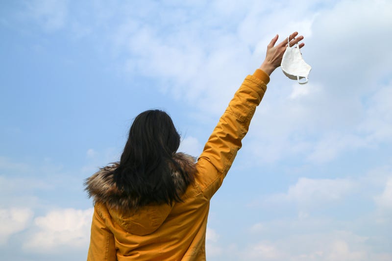 Woman tossing mask stock photo. 