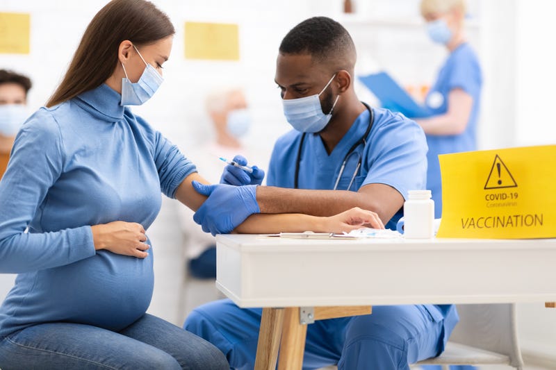 A pregnant woman getting the COVID-19 shot.