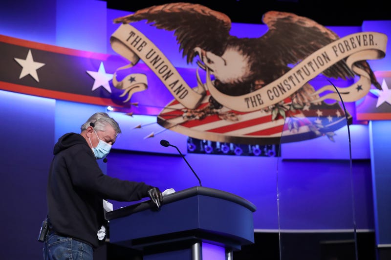 A person uses disinfecting wipes to clean the lectern that will be used by President Donald Trump during the second presidential debate at the Curb Event Center on the campus of Belmont University on October 22, 2020 in Nashville, Tennessee. President Trump and Democratic presidential nominee Joe Biden are scheduled to square off for the final debate, 12 days before Election Day. 