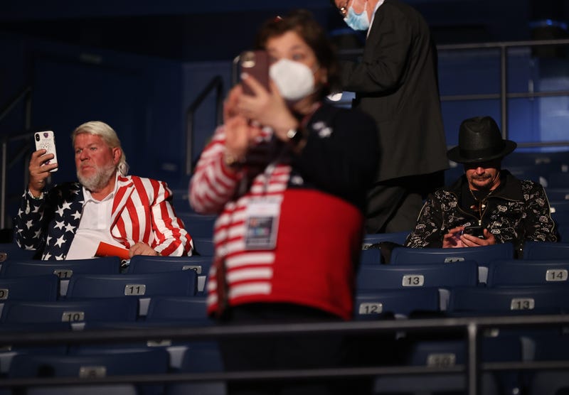 Kid Rock (R) and John Daly take their seats without wearing masks, prior to being asked to wear them, at the final presidential debate between U.S. President Donald Trump and Democratic presidential nominee Joe Biden at Belmont University on October 22, 2020 in Nashville, Tennessee. This is the last debate between the two candidates before the election on November 3. 
