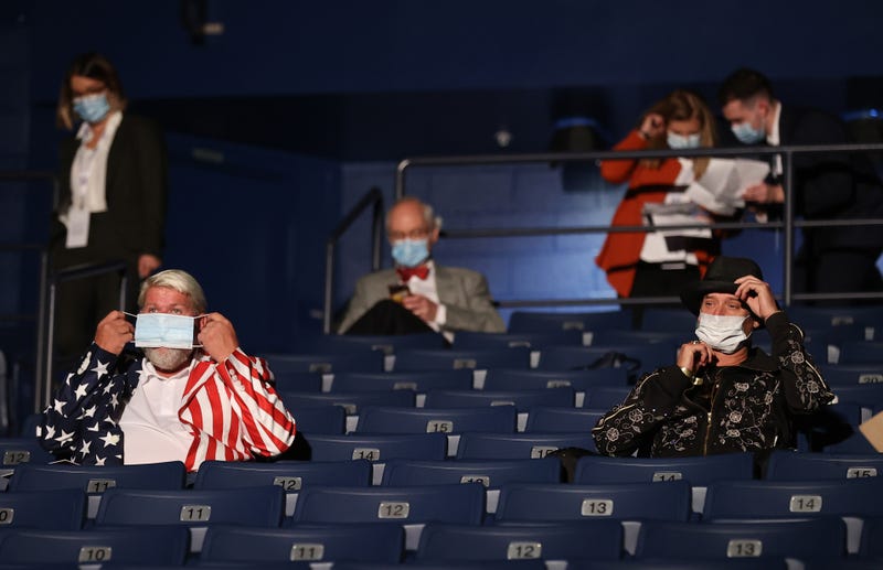 Kid Rock (R) and John Daly put on masks after being asked to wear them, at the final presidential debate between U.S. President Donald Trump and Democratic presidential nominee Joe Biden at Belmont University on October 22, 2020 in Nashville, Tennessee. This is the last debate between the two candidates before the election on November 3. 