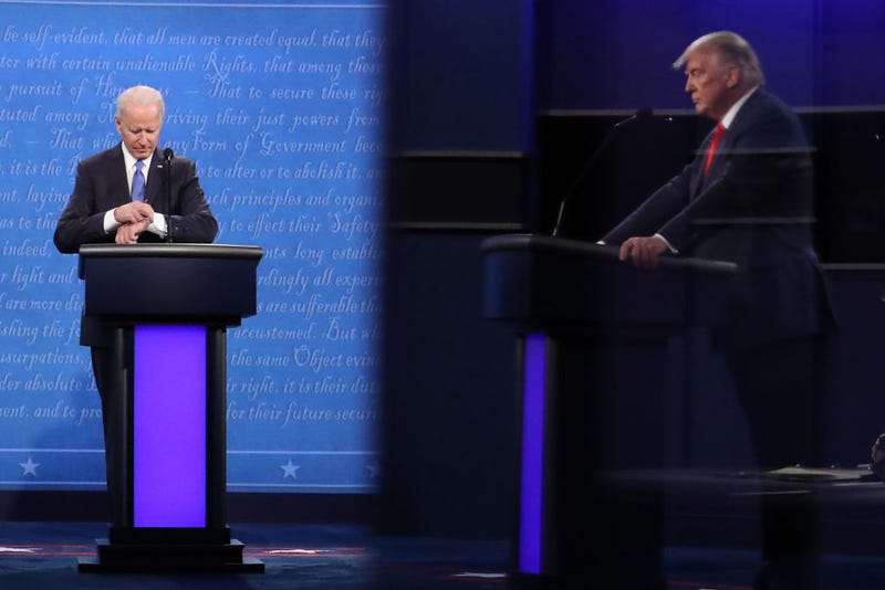 Then-Democratic presidential nominee Joe Biden checks his watch during the final presidential debate against then-U.S. President Donald Trump (shown in reflection) at Belmont University on October 22, 2020 in Nashville, Tennessee.