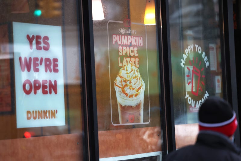 A man walks past a Dunkin' store on October 26, 2020 in New York City. The Dunkin’ Brands, the parent company of the Dunkin’ and Baskin Robbins chains, is in negotiations to sell itself to Inspire Brand, a private equity-backed company. 