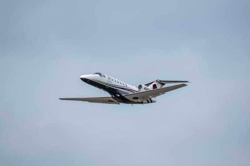 cessna business jet flying in sky