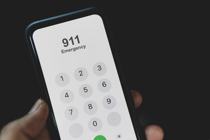 Close up of a cell phone with nine-one-one dialed