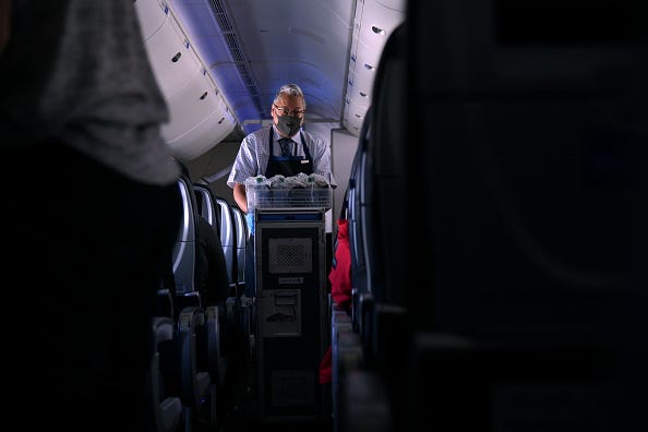 Flight attendant wearing a mask.