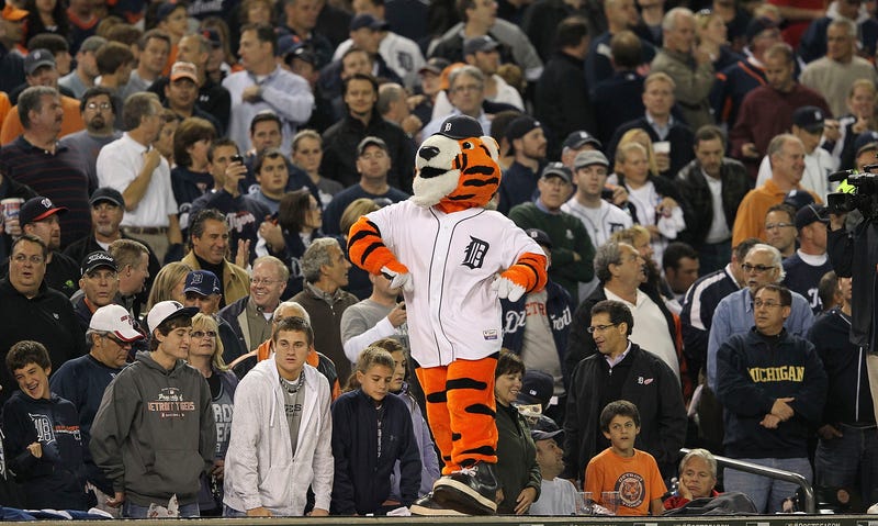 Detroit Tigers mascot Paws on top of the dugout