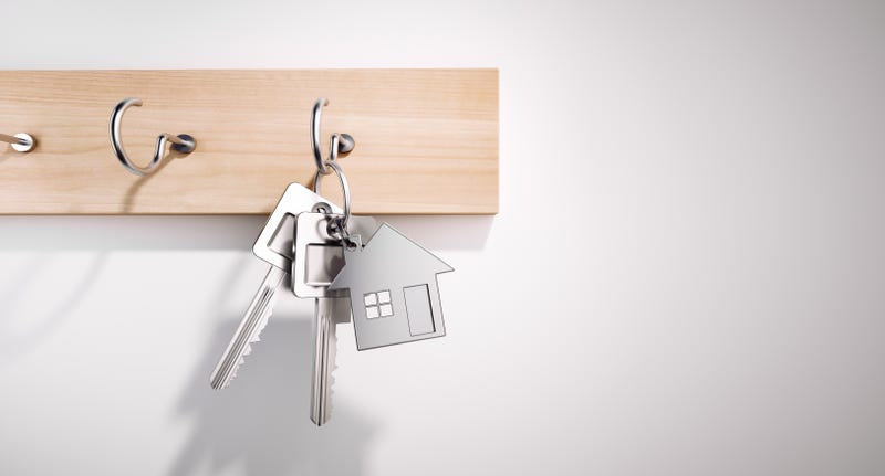 House Keys with Key Ring hanging on wooden Board