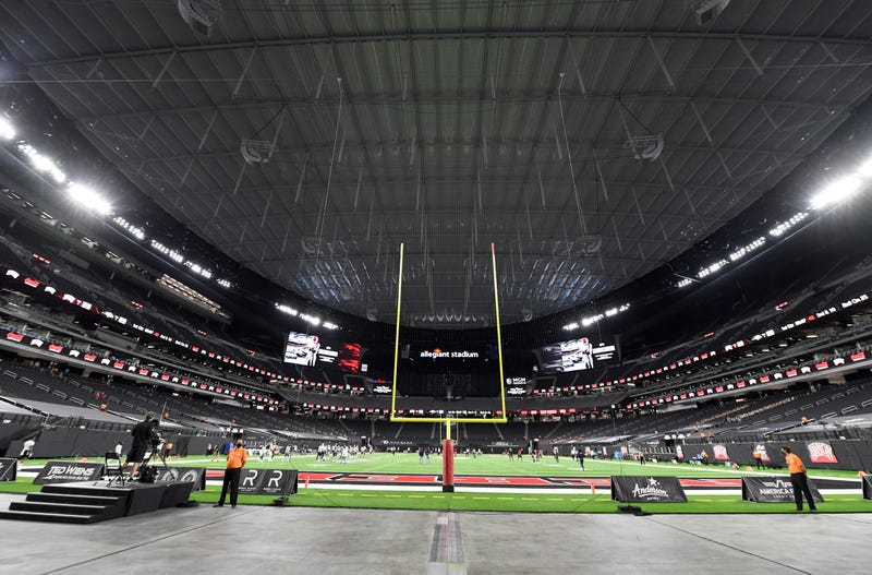 Nevada Wolf Pack and UNLV Rebels players warm up before their game at Allegiant Stadium
