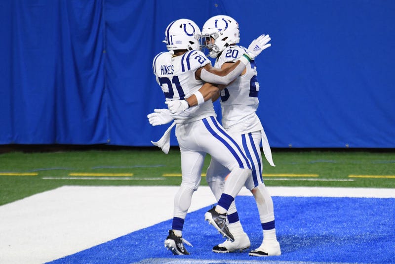 Nyheim Hines and Jordan Wilkins celebrate in the end zone after a touchdown.