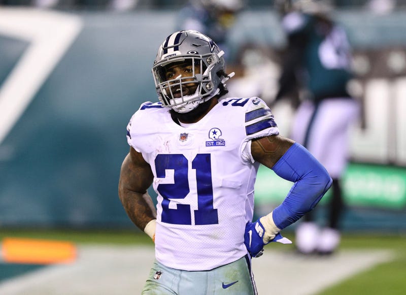 Running back Ezekiel Elliott #21 of the Dallas Cowboys looks on as Rodney McLeod #23 of the Philadelphia Eagles celebrates with Avonte Maddox #29 in the background.