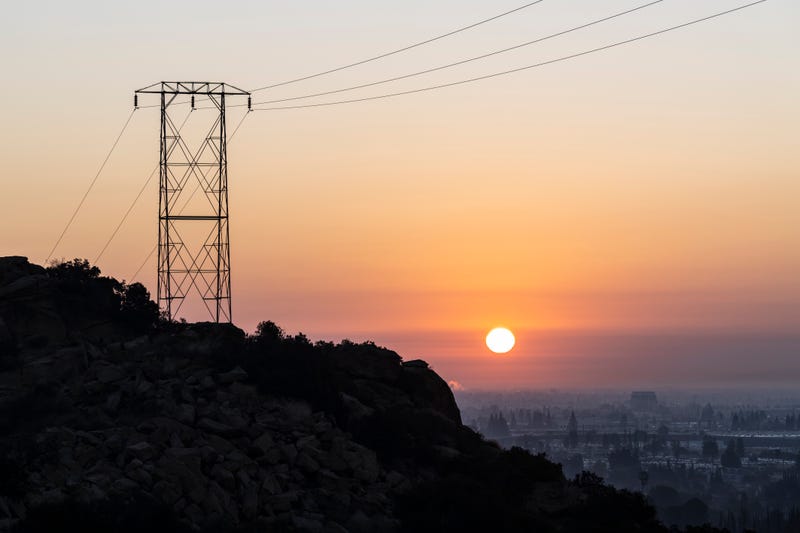 power lines on a hilltop at sunrise