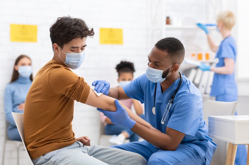 A doctor giving a patient a COVID-19 vaccine.