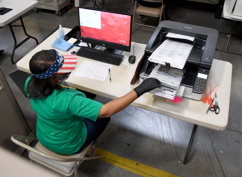 A Clark County election worker scans mail-in ballots at the Clark County Election Department on November 7, 2020 in North Las Vegas, Nevada.
