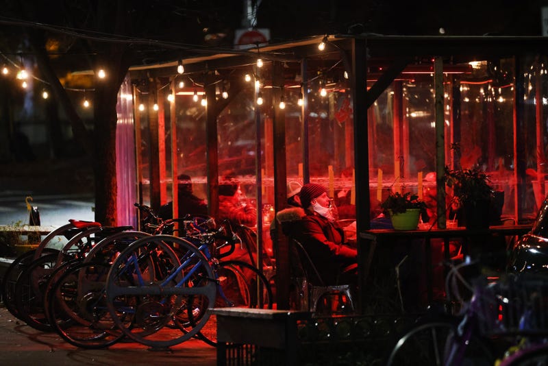 People eat in a covered outdoor area at a restaurant and bar on November 13, 2020.