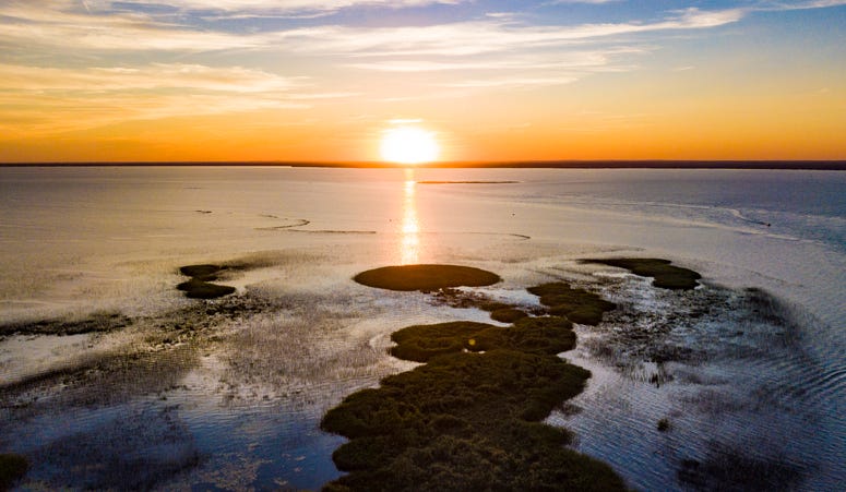 An aerial view of the sun setting on Lake Saint Clair, Michigan.