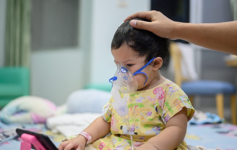 Young infant, sick with RSV, gets a breathing treatment at hospital.