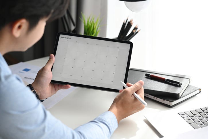 Businessman Looking At Calendar