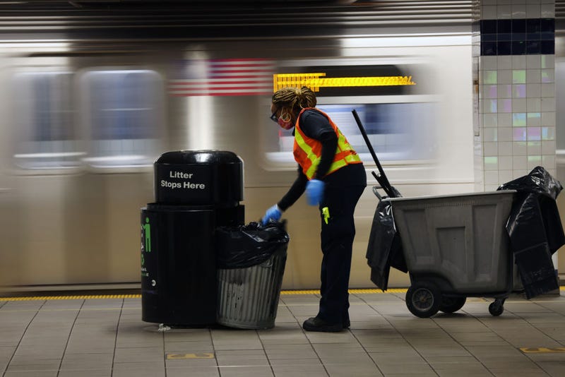 A Metropolitan Transportation Authority (MTA) worker empties trash at a Brooklyn station on November 18, 2020 in New York City.