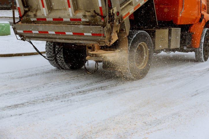 Snow plow salting icy roads. 
