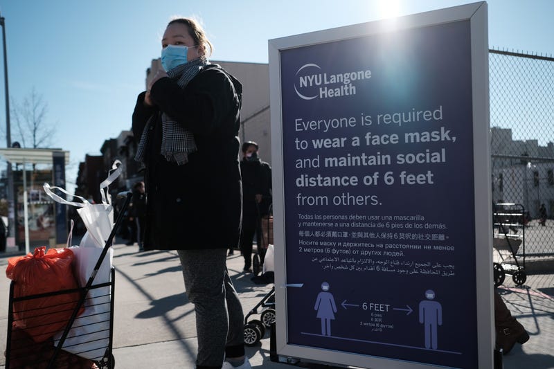 People receive bags of food, including turkeys, at a Thanksgiving food distribution sponsored by area health centers, churches and local politicians on November 20, 2020 in New York City. 