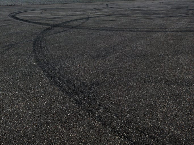 tracks on pavement in a stock image