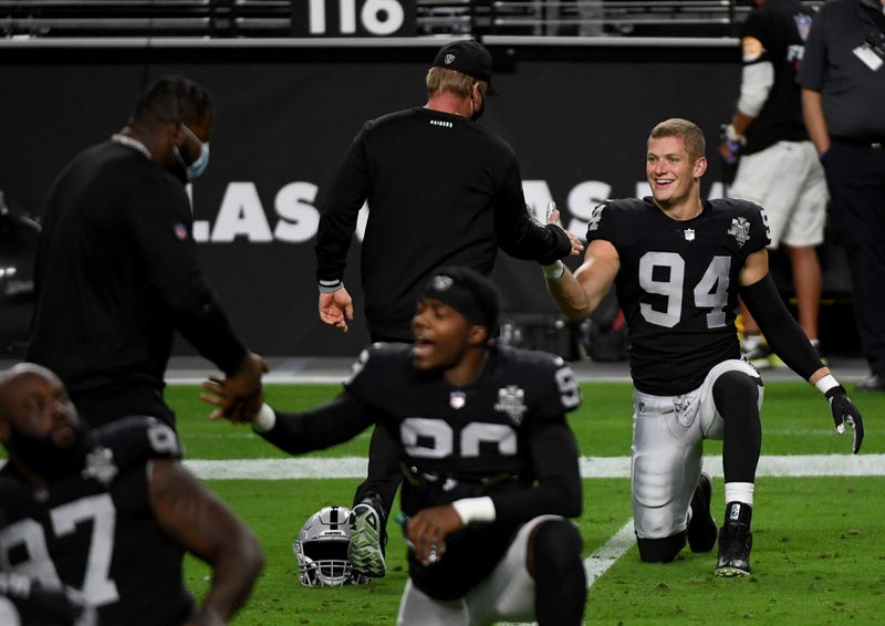 Defensive end Carl Nassib #94 of the Las Vegas Raiders is greeted by head coach Jon Gruden during warmups before a game against the Kansas City Chiefs at Allegiant Stadium on November 22, 2020 in Las Vegas, Nevada.