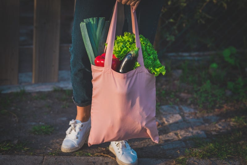 Close up of pink reusable eco bag with vegetables.
