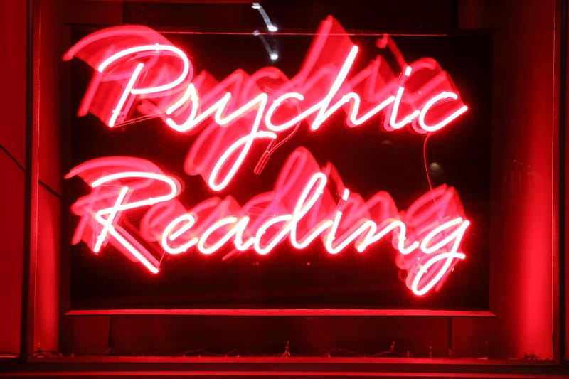 Blurred camera pan of a red neon business sign
