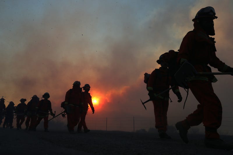 Firefighters work to put out a blaze near Irvine, California.