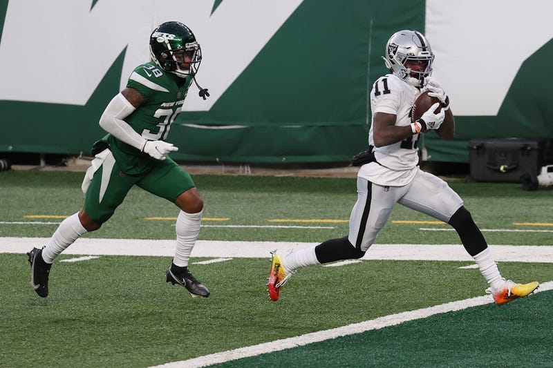 Henry Ruggs III #11 of the Las Vegas Raiders scores a touchdown to win the game as Lamar Jackson #38 of the New York Jets gives chase during the second half at MetLife Stadium on December 06, 2020 in East Rutherford, New Jersey.
