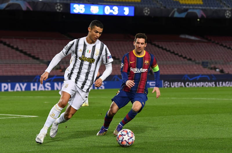 ristiano Ronaldo of Juventus F.C. is put under pressure by Lionel Messi of Barcelona during the UEFA Champions League Group G stage match between FC Barcelona and Juventus at Camp Nou on December 08, 2020 in Barcelona, Spain.