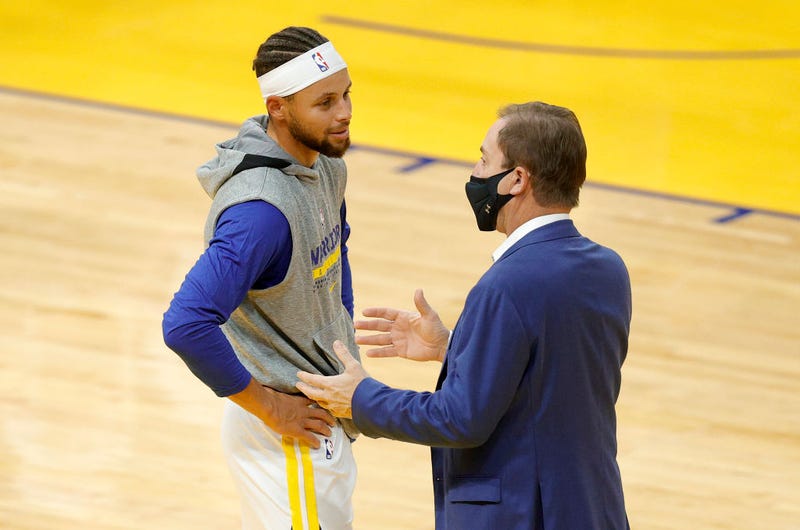 Stephen Curry #30 of the Golden State Warriors talks to Warriors' owner Joe Lacob before their NBA preseason game against the Denver Nuggets at Chase Center on December 12, 2020 in San Francisco, California.