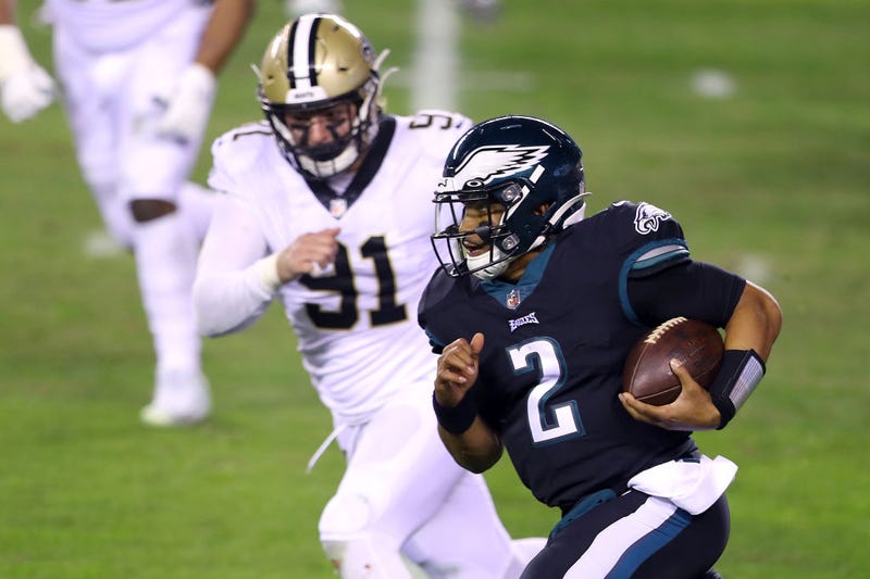 Jalen Hurts sprints past a Saints defender.