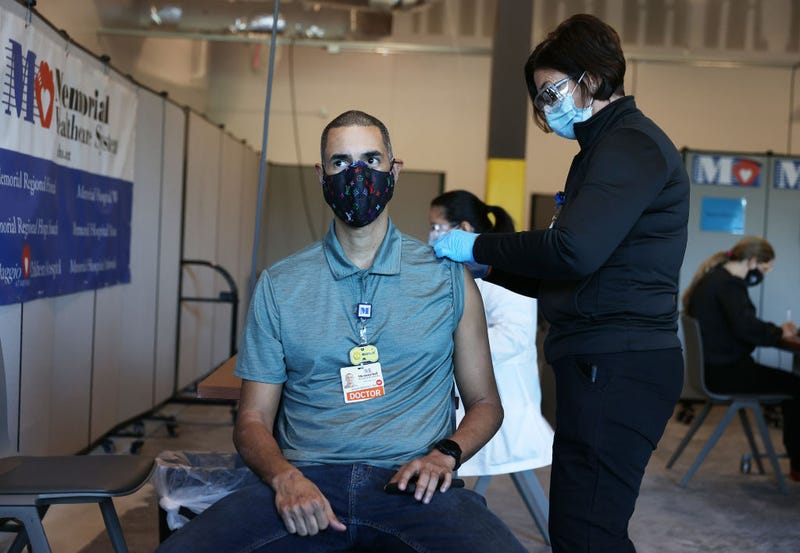 Brian Mendez, MD at the Memorial Healthcare System, receives a Pfizer-BioNtech Covid-19 vaccine