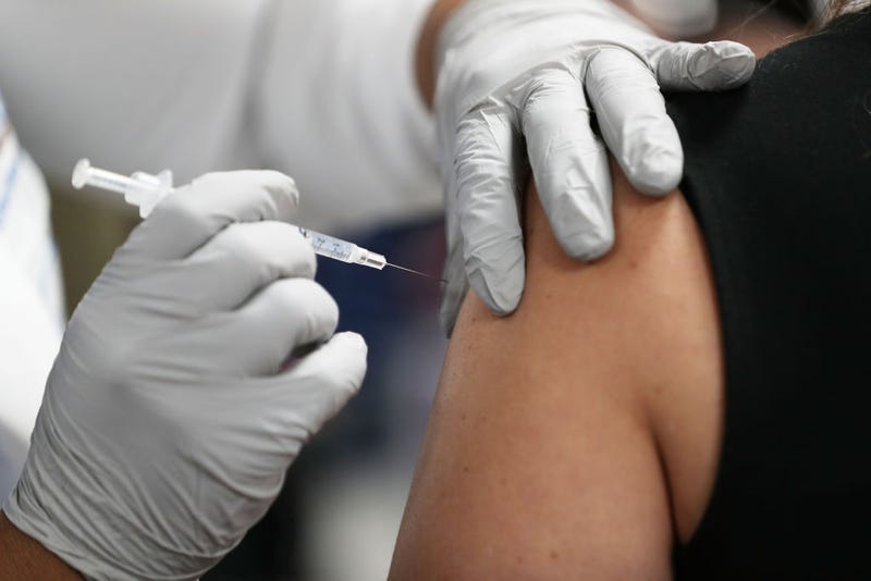 A healthcare worker at the Jackson Health Systems receives a Pfizer-BioNtech Covid-19 vaccine from Susana Flores Villamil, RN from Jackson Health Systems, at the Jackson Memorial Hospital on December 15, 2020 in Miami, Florida.